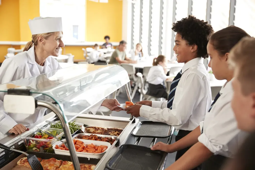 high-school-students-wearing-uniform-being-served-2024-10-19-18-31-39-utc-scaled-1-scaled
